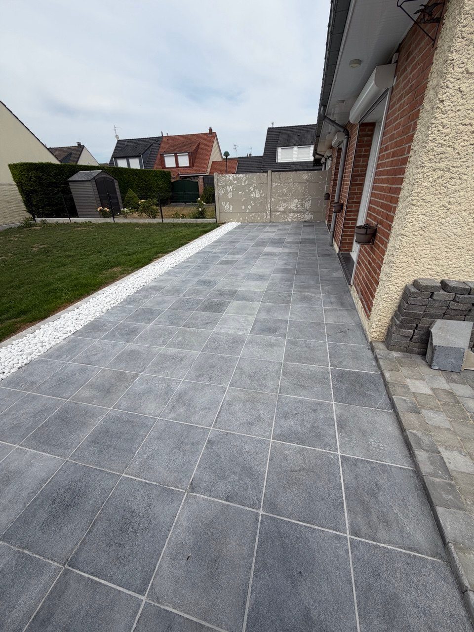 Terrasse pierre bleue 40x40 et bande drainante galet blanc à Achicourt – Hpaysage